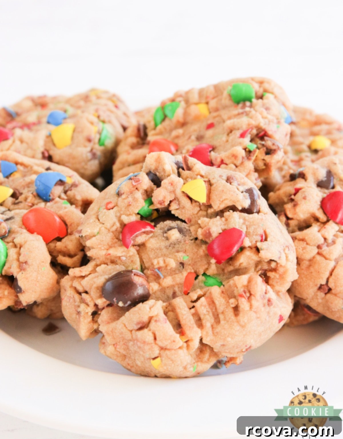 Peanut Butter M&M Cookie Perfection 7 A batch of freshly baked Peanut Butter Cookies with Peanut Butter M&Ms, presented beautifully on a plate.