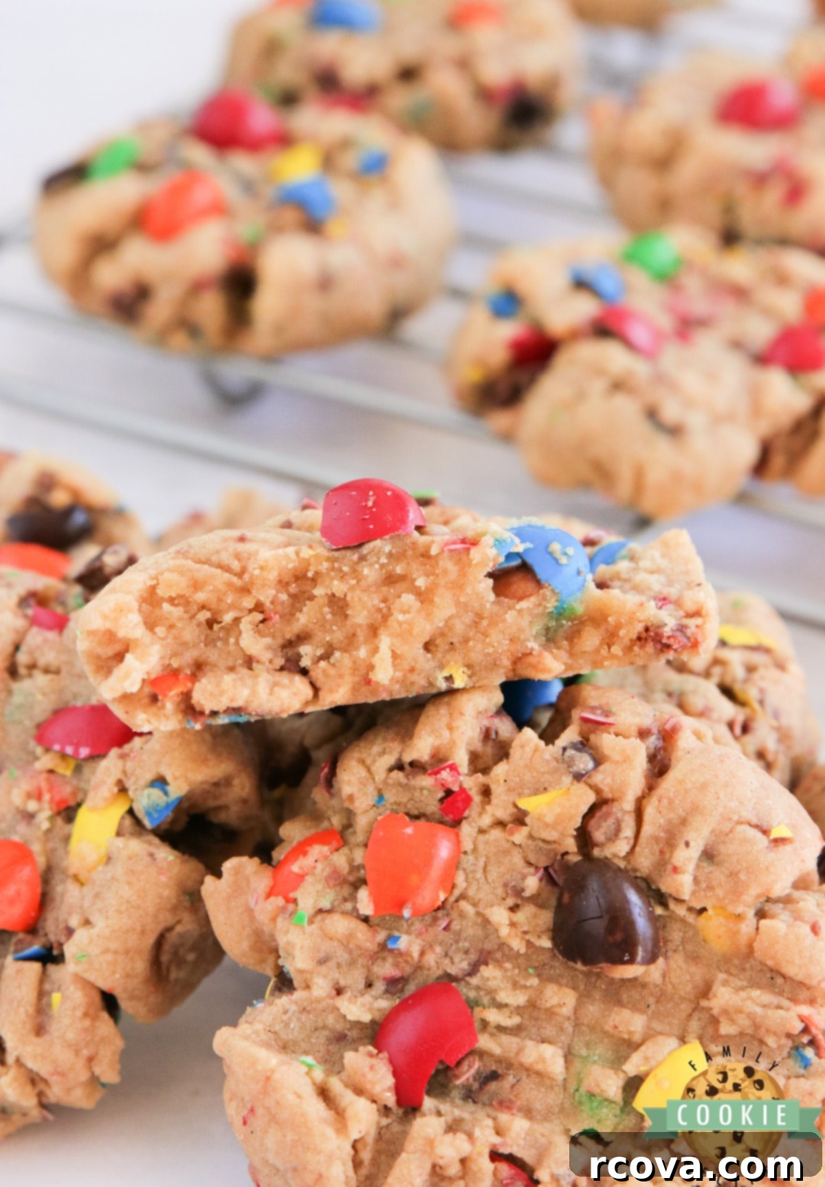 Peanut Butter M&M Cookie Perfection 9 A large pile of freshly baked, soft, and chewy Peanut Butter M&M Cookies, showcasing their vibrant colors and appealing texture, ready to be enjoyed.