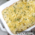 Golden Smoked Gouda Cauliflower Bake 5 low carb, keto Smoked Gouda Cauliflower Casserole, garnished with fresh chives