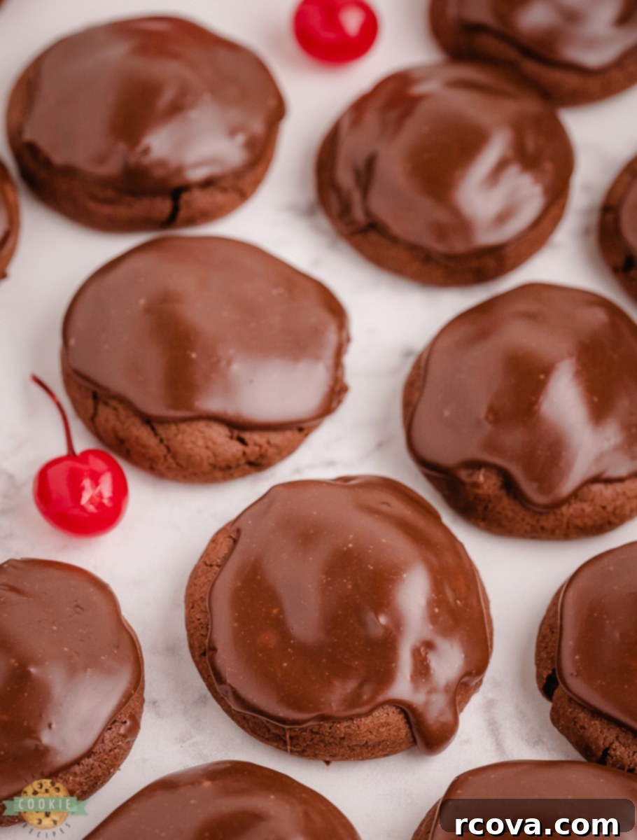 Decadent Double Chocolate Cherry Cookies 4 Close-up of rich chocolate cherry cookies on a cooling rack, showcasing the shiny fudge topping