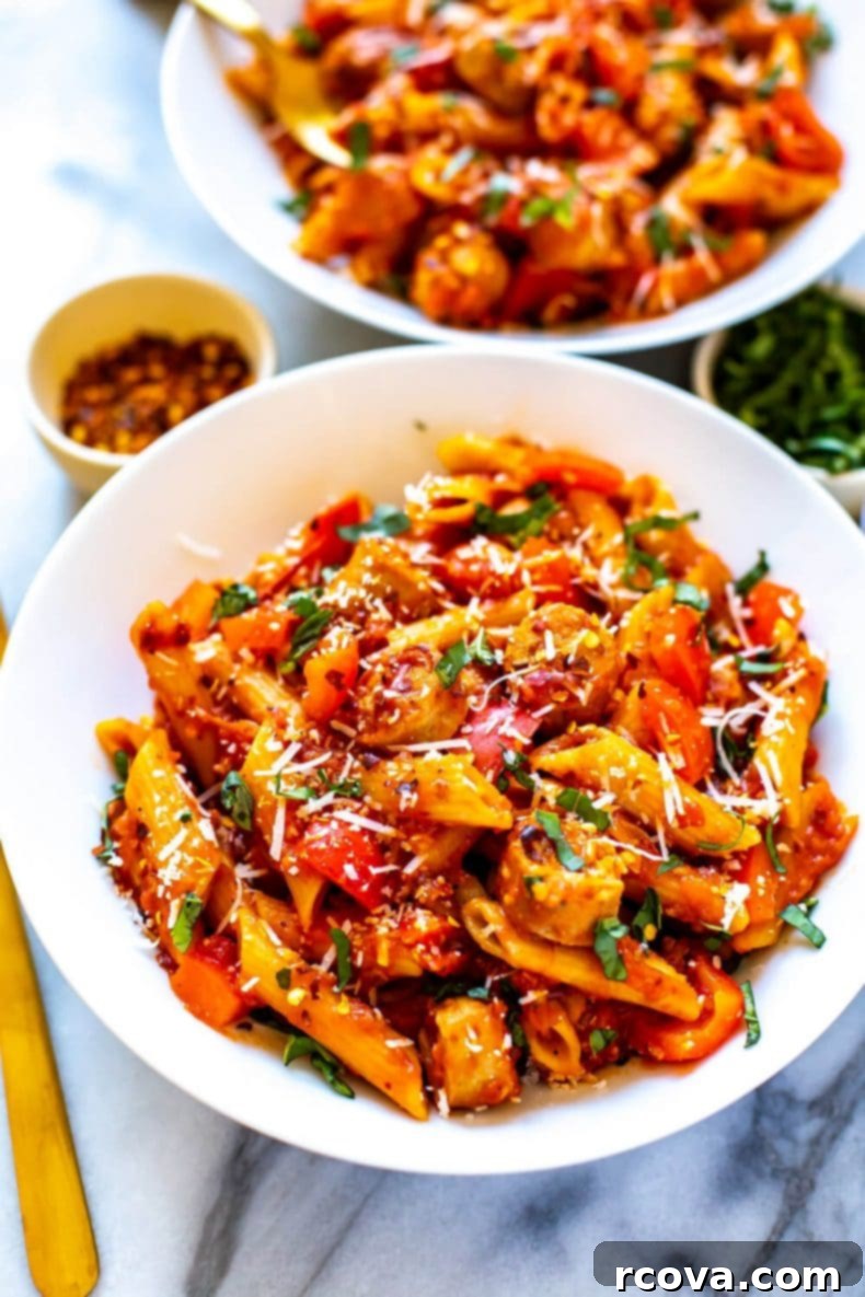 This wholesome Pasta Arrabiata, enriched with lean turkey sausage and colorful bell peppers, offers a flavorful and quick one-pot dinner solution ready in 30 minutes. A close-up of Pasta Arrabiata made with turkey sausage pieces and red bell peppers, emphasizing the ingredients within the spicy sauce.
