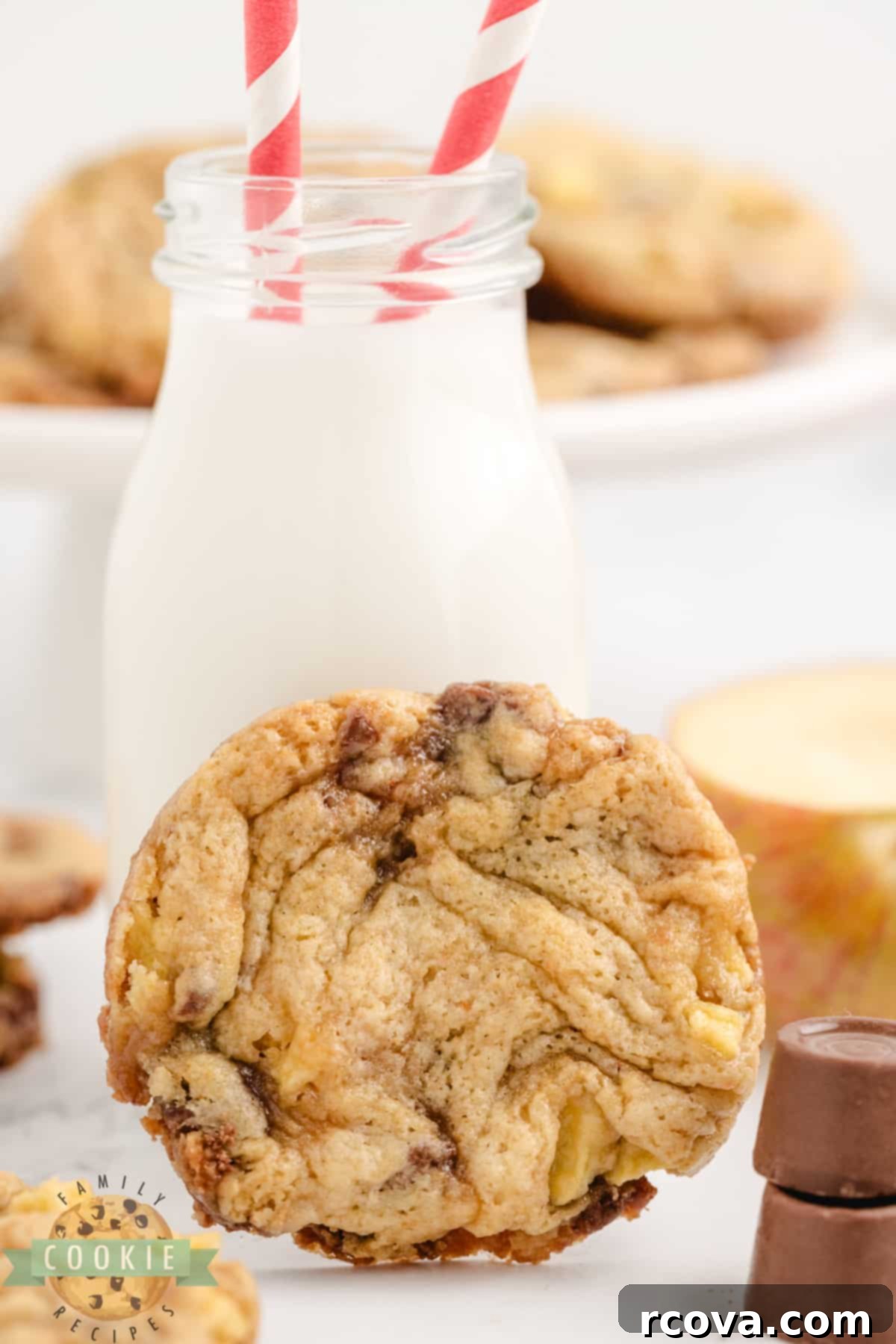 Irresistible Caramel Apple Cake Mix Cookies 2 Close-up of freshly baked Caramel Apple Cake Mix Cookies on a wire rack, showcasing the golden-brown edges, soft centers, and visible pieces of apple and melted Rolo candy.
