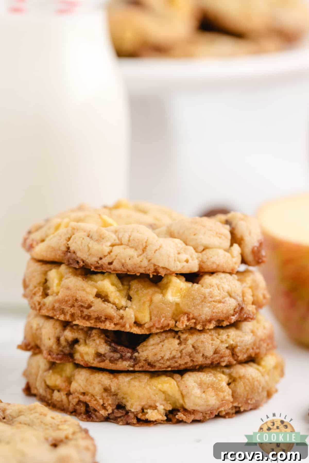 Irresistible Caramel Apple Cake Mix Cookies 10 A stack of three soft, chewy Caramel Apple Cake Mix Cookies with visible apple pieces and gooey caramel from Rolos.