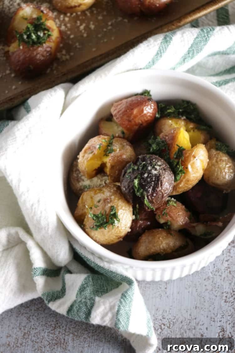 Crispy Garlic Smashed Potatoes Roasted in Duck Fat 5 Close up of crispy garlic smashed potatoes with fresh herbs