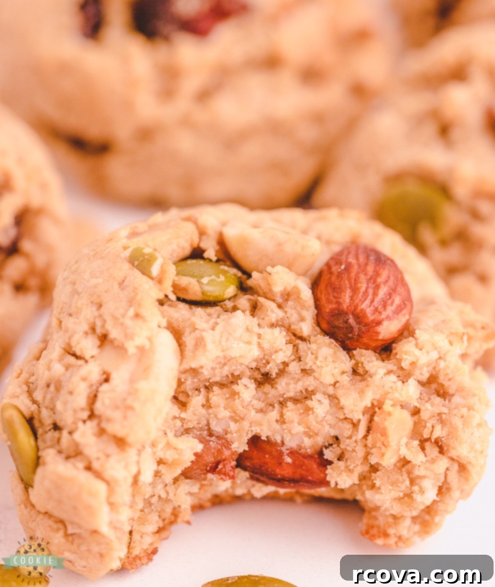 Trail Mix Peanut Butter Cookies: The Adventurous Bite 3 Close-up of a bitten trail mix peanut butter cookie showing the oats and nuts inside.