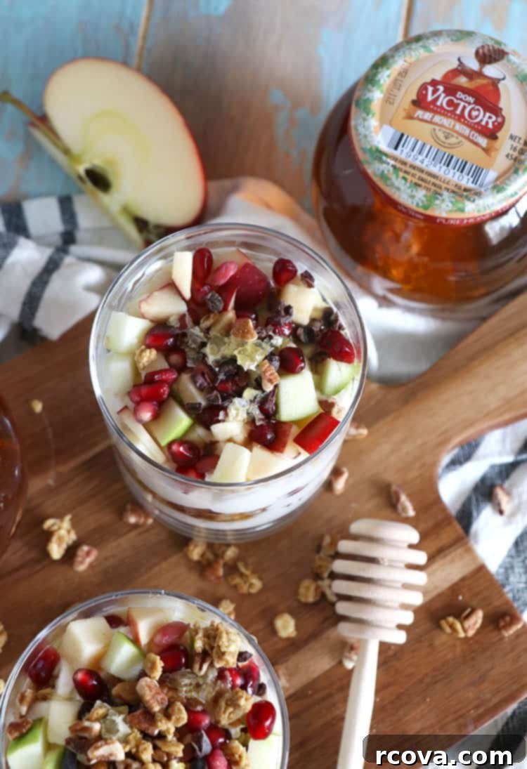 Cozy Winter Parfaits 2 Colorful winter fruit parfaits in elegant glasses, garnished with fresh fruit and nuts, on a festive holiday table.