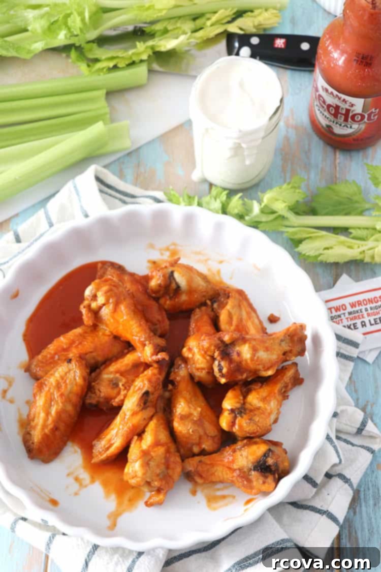 Guilt-Free Crispy Buffalo Wings 2 Close-up of crispy air fryer buffalo chicken wings, glistening with hot sauce.