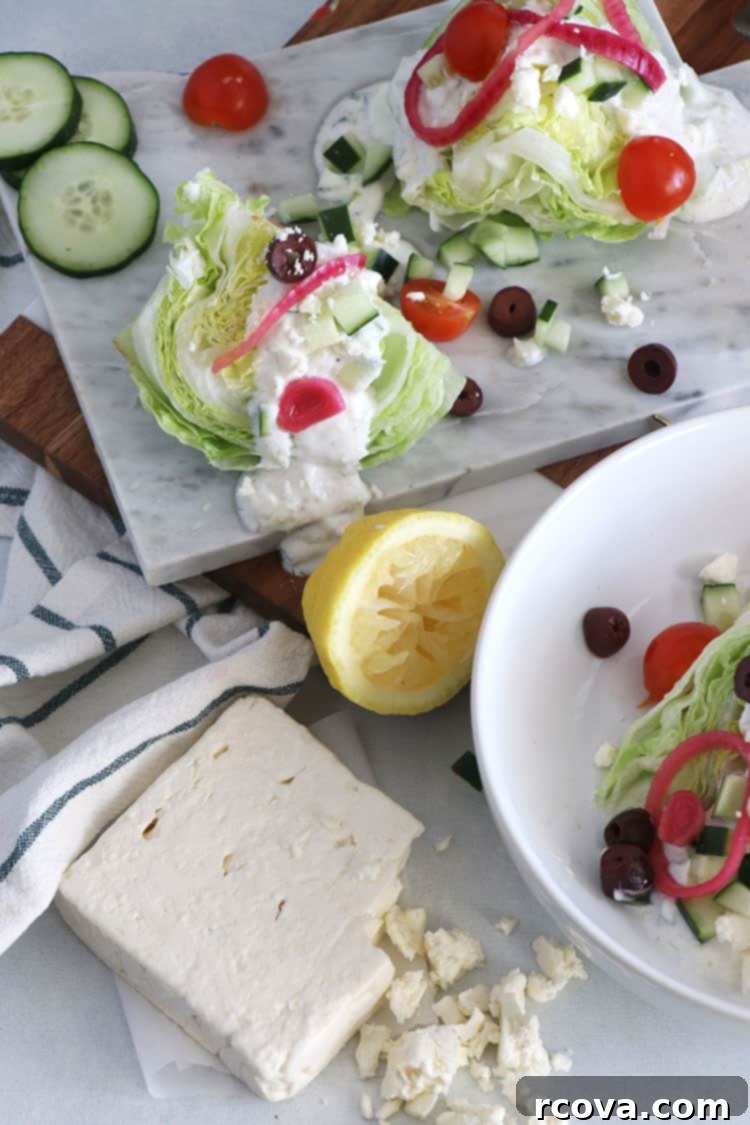 Vibrant Greek Wedge with Tangy Tzatziki Vinaigrette 3 Close-up of Greek Wedge Salad with crisp lettuce, vibrant toppings, and creamy Tzatziki Vinaigrette.