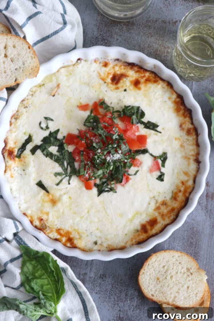 Irresistible Oven-Baked Creamy Mozzarella Dip 2 Creamy Mozzarella and Burrata Dip baked to a golden brown in a white baking dish.