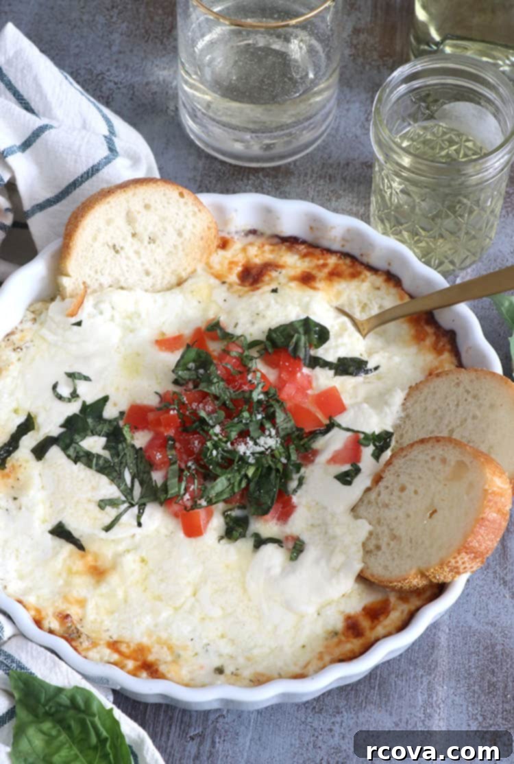 Irresistible Oven-Baked Creamy Mozzarella Dip 5 Overhead shot of the finished Creamy Mozzarella Dip with Burrata and Basil, garnished with diced tomatoes and fresh basil.
