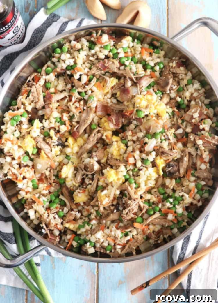 Cauliflower Chicken Fried Rice Whole30 Keto Paleo Approved 2 Cauliflower Chicken Fried Rice served in a bowl, showcasing the vibrant vegetables and chicken pieces.
