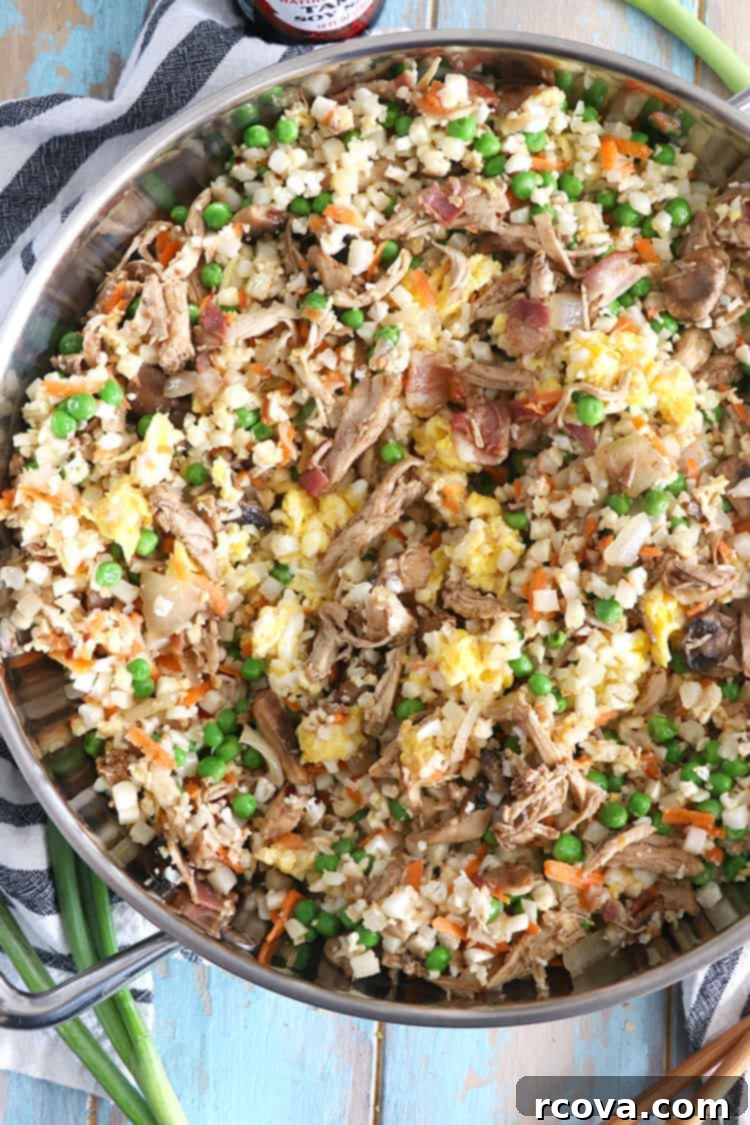 Cauliflower Chicken Fried Rice Whole30 Keto Paleo Approved 4 A serving of Cauliflower Chicken Fried Rice garnished with green onions and ready to eat.