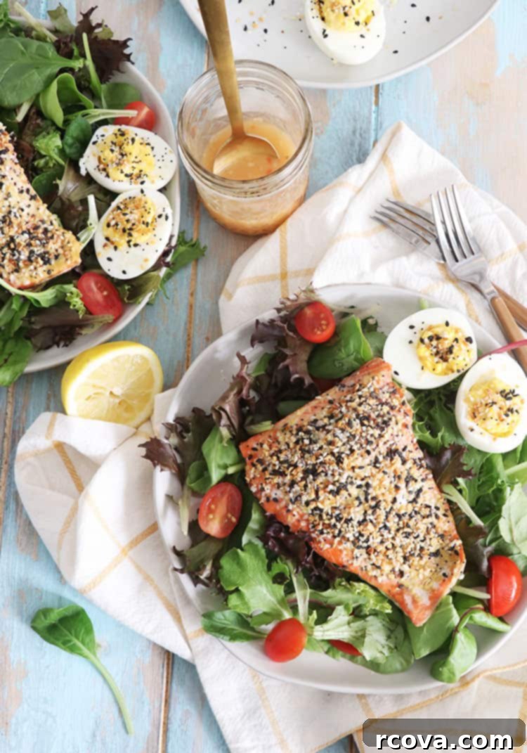 3 Ingredient Oven Baked Everything Bagel Salmon 2 Fresh salmon fillets generously seasoned with everything bagel spice on a baking sheet, ready for the oven.