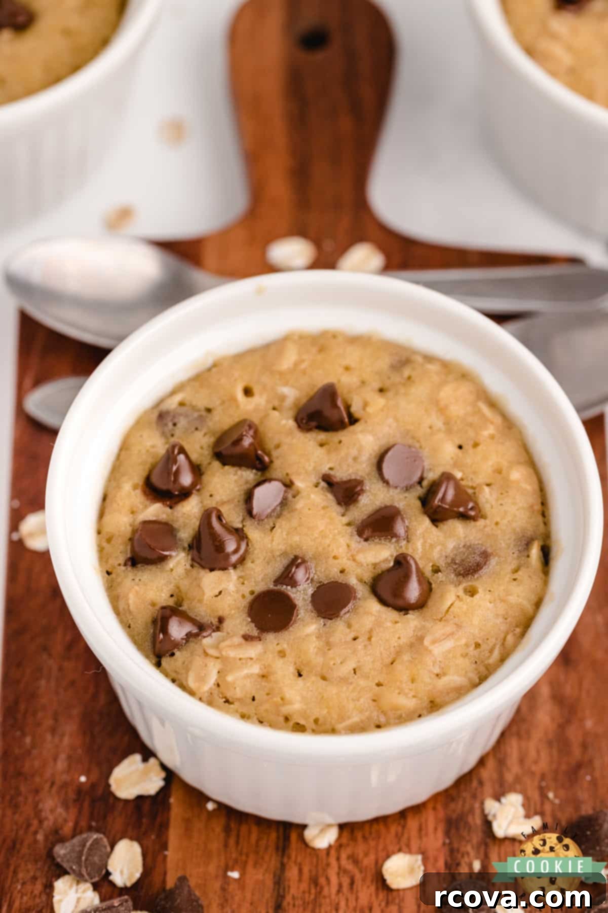 Easy Microwave Oatmeal Chocolate Chip Cookies 8 Individual oatmeal chocolate chip cookies baked in mugs, showcasing their perfect portion size and homemade appeal.