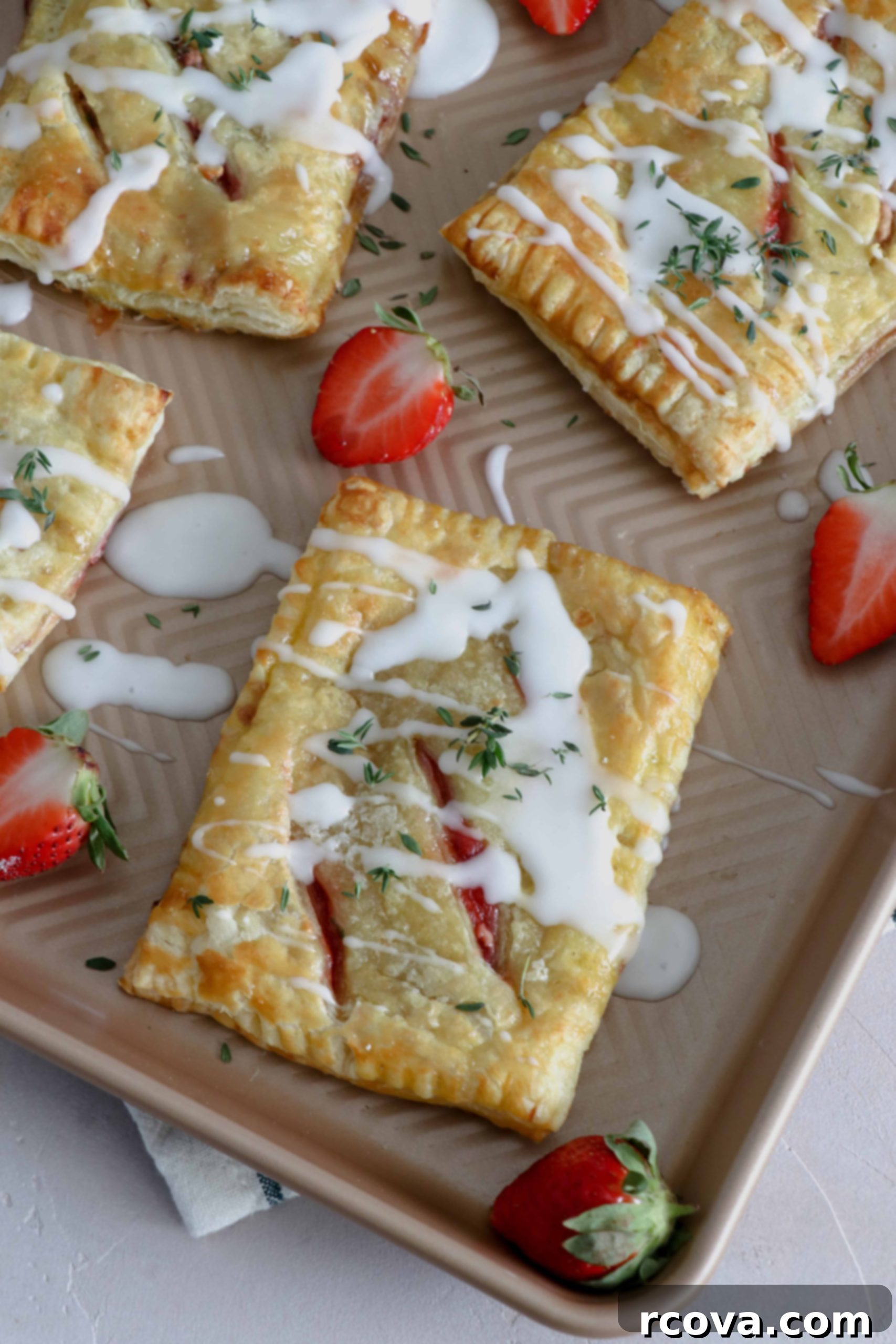 Strawberry Thyme Chevre Pockets 8 Close-up of a strawberry, thyme, and goat cheese hand pie with a fork, ready to be eaten.