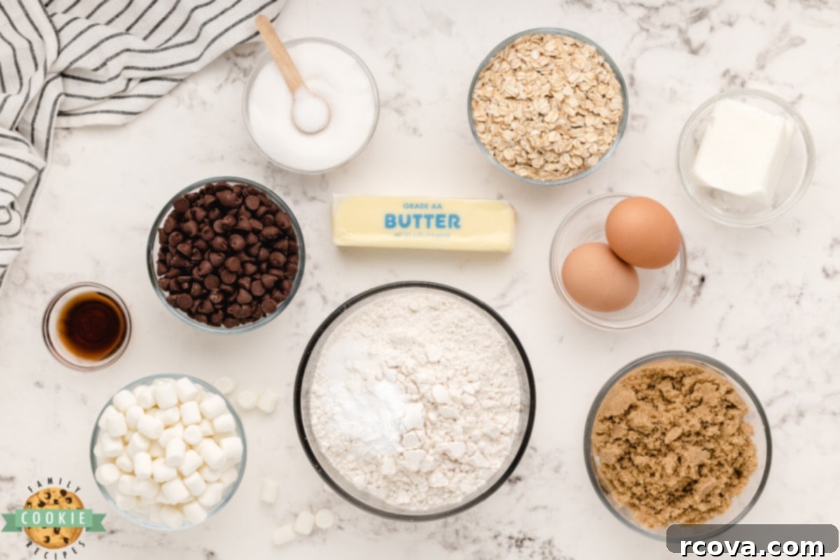 Toasted Marshmallow Oat Delights 3 Key ingredients laid out for S'mores Oatmeal Cookies, including butter, sugars, eggs, flour, oats, chocolate chips, and mini marshmallows.