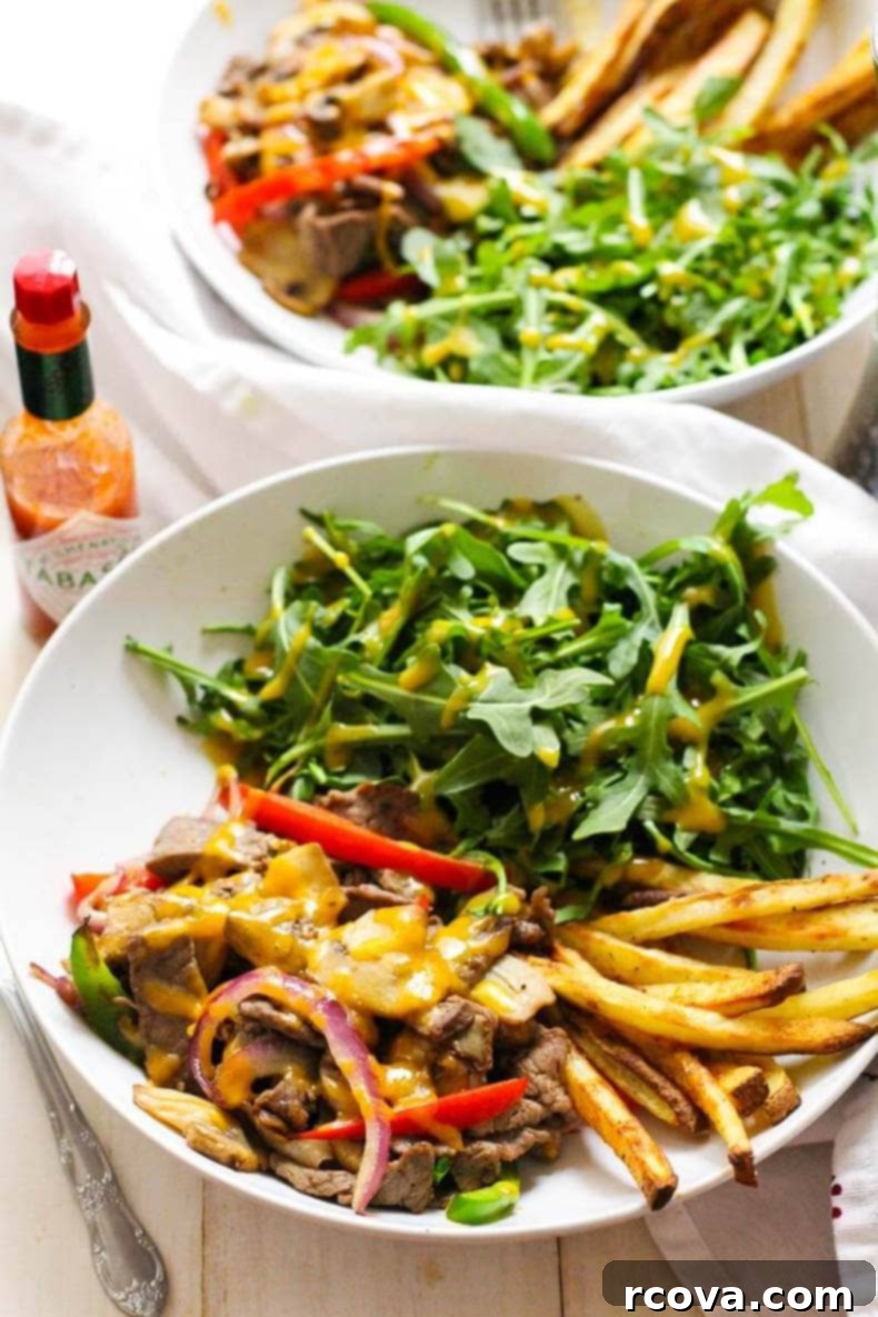 Low Carb Philly Cheesesteak Salad Bowls 6 Philly Cheesesteak Salad Bowl presented beautifully with steak, cheese, peppers, onions, and golden-brown fries.