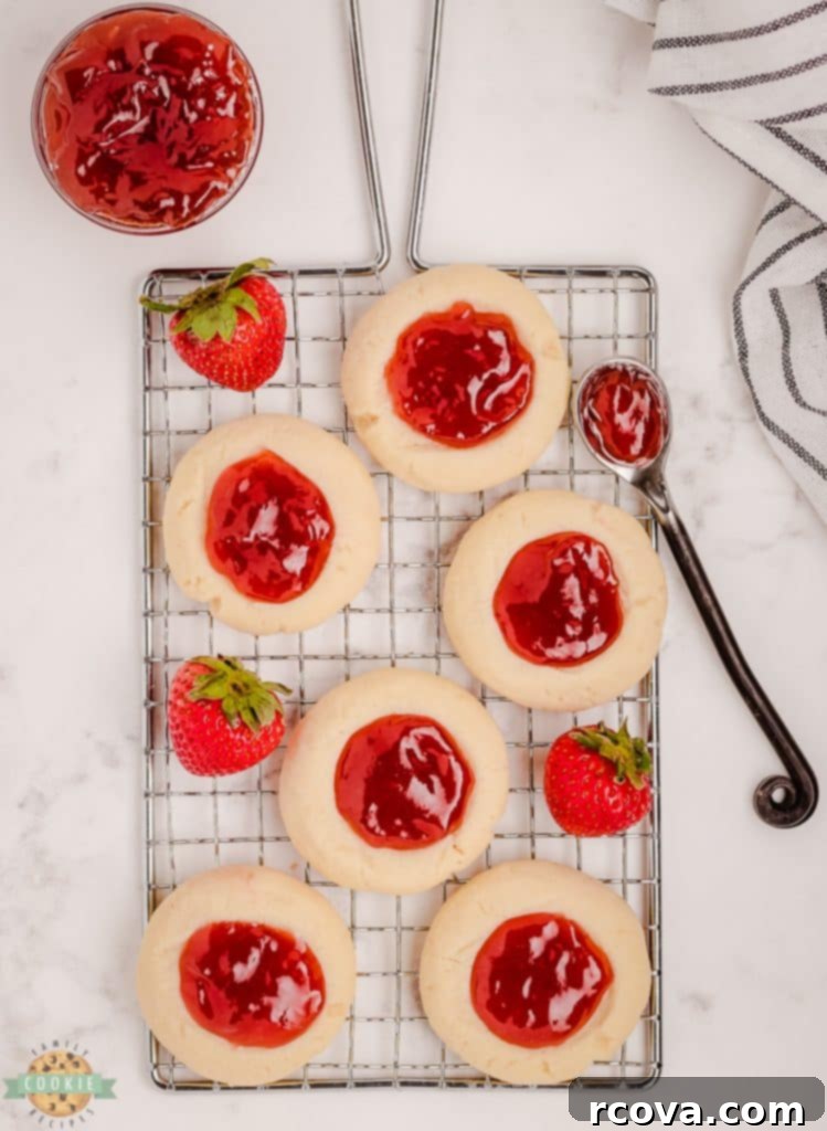Strawberry Thumbprint Cookies: A Sweet and Simple Classic 3 Freshly baked strawberry thumbprint cookies cooling on a wire rack