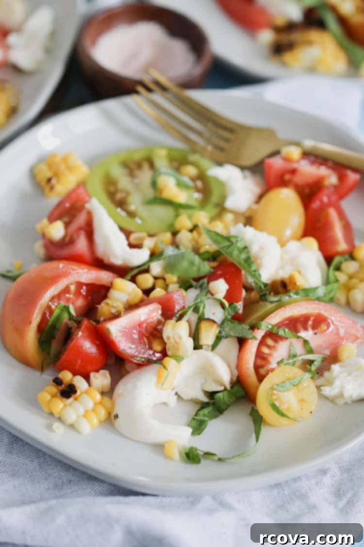 Fire Kissed Corn and Tomato Caprese 7 Serving of Charred Corn Caprese Salad on a plate
