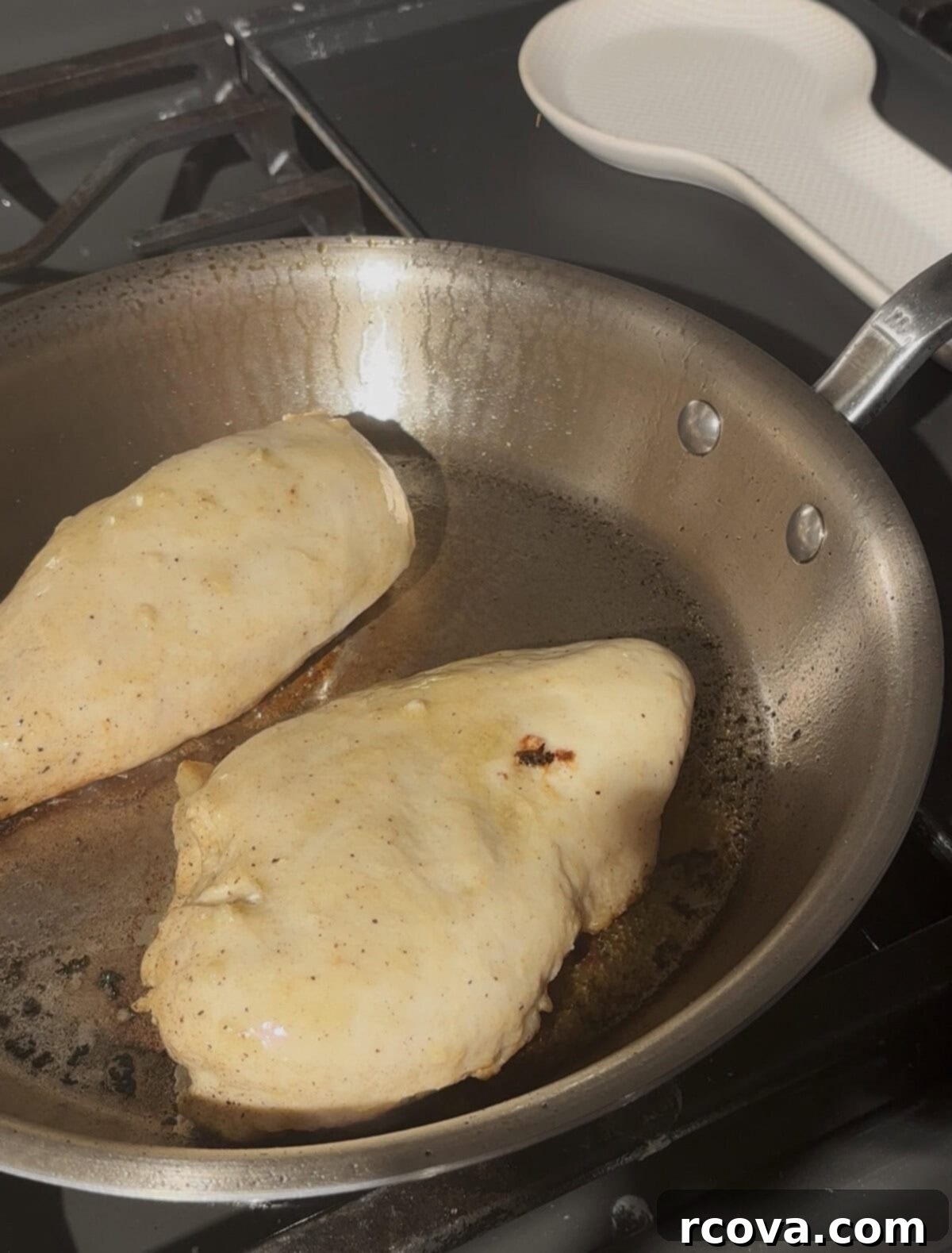 Dijon-Kissed Grilled Chicken & Bacon Salad 6 Chicken breast cooking in a stainless steel skillet, browning nicely.