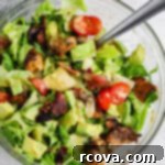 Dijon-Kissed Grilled Chicken & Bacon Salad 8 A vibrant grilled chicken salad with crispy bacon, fresh greens, and a tangy Dijon vinaigrette in a bowl.