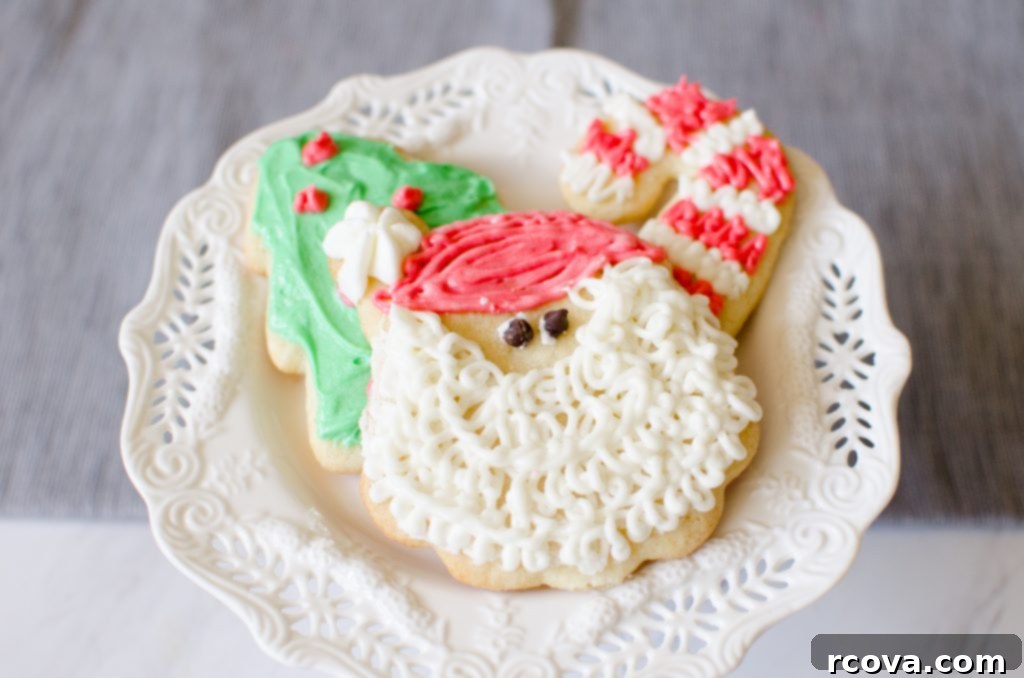 Classic Christmas Sugar Cookie Recipe 2 Classic Christmas sugar cookies decorated with festive buttercream frosting and sprinkles, a perfect holiday treat.