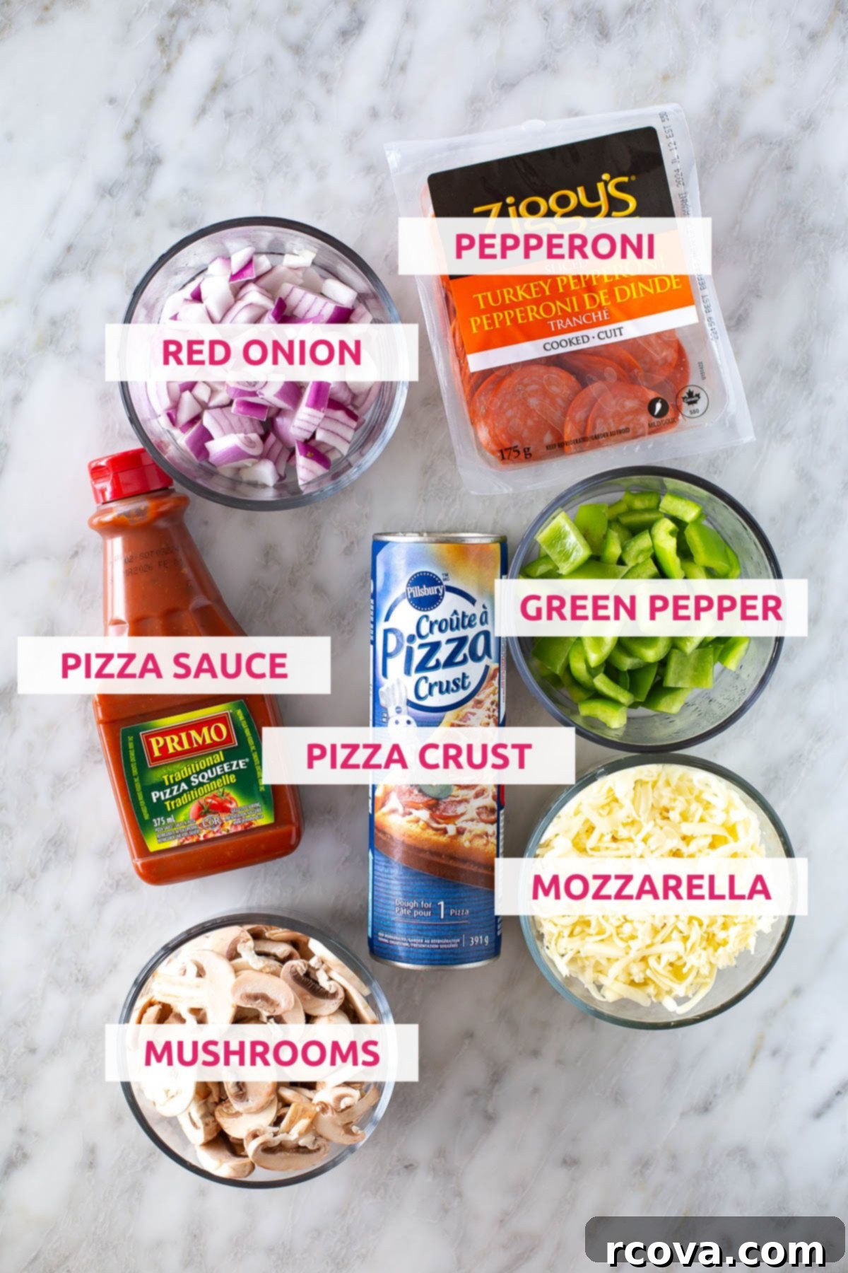 Whip Up Delicious Homemade Pizza Pockets 4 Ingredients for homemade pizza pockets laid out: canned pizza crust, pepperoni, red onion, green peppers, pizza sauce, shredded mozzarella, and sliced mushrooms