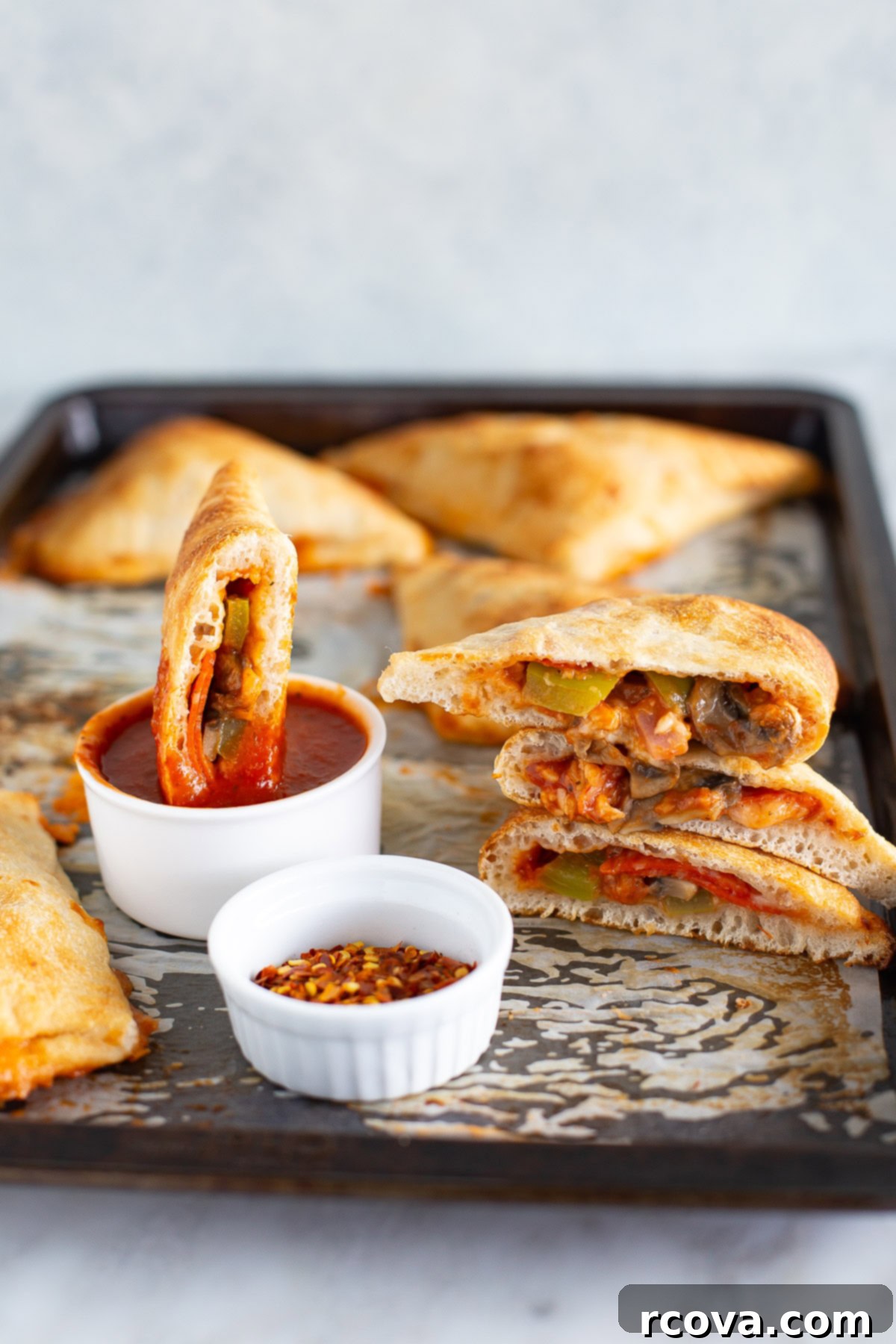 Whip Up Delicious Homemade Pizza Pockets 8 A stack of homemade pizza pockets garnished with fresh basil, ready to be enjoyed