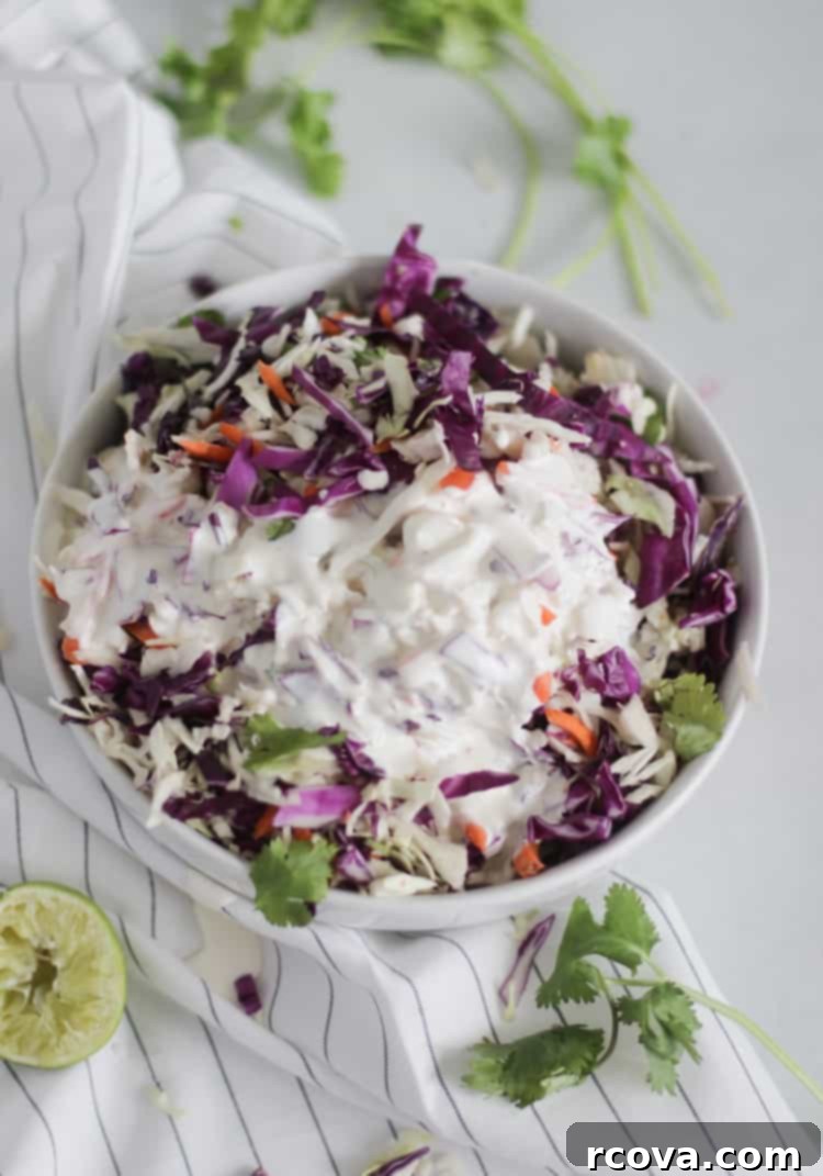Zesty Cilantro Lime Slaw (Low-Carb) 4 A large bowl of delicious Cilantro Lime Coleslaw, garnished with extra fresh cilantro, ready to be served at a summer barbecue.