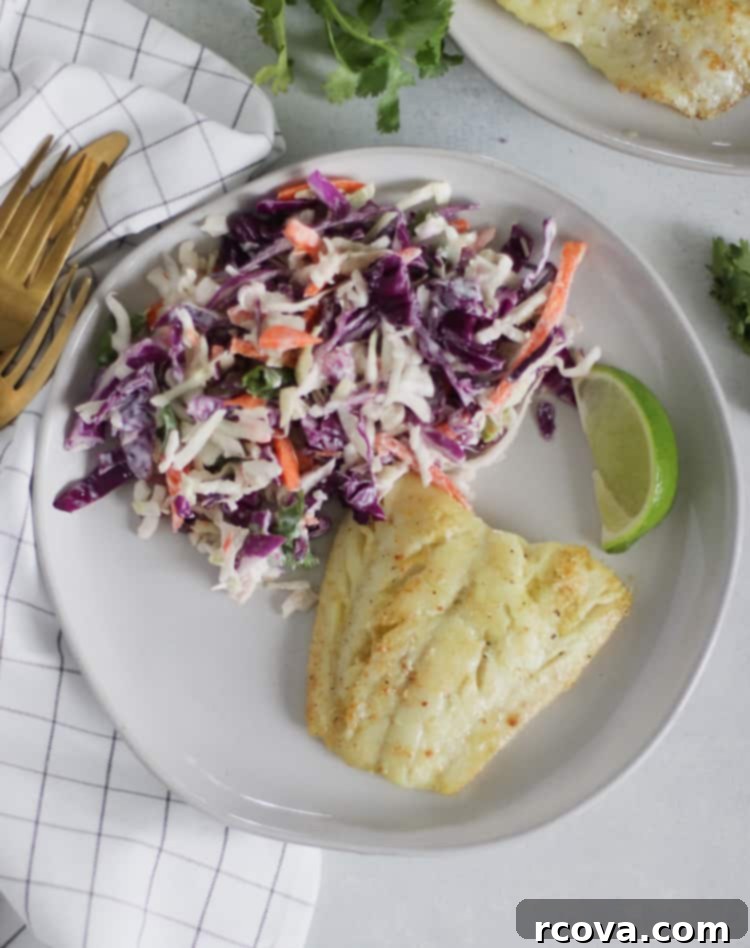 Zesty Cilantro Lime Slaw (Low-Carb) 6 Freshly mixed Cilantro Lime Coleslaw in a white bowl with serving spoon, ready for a healthy meal.