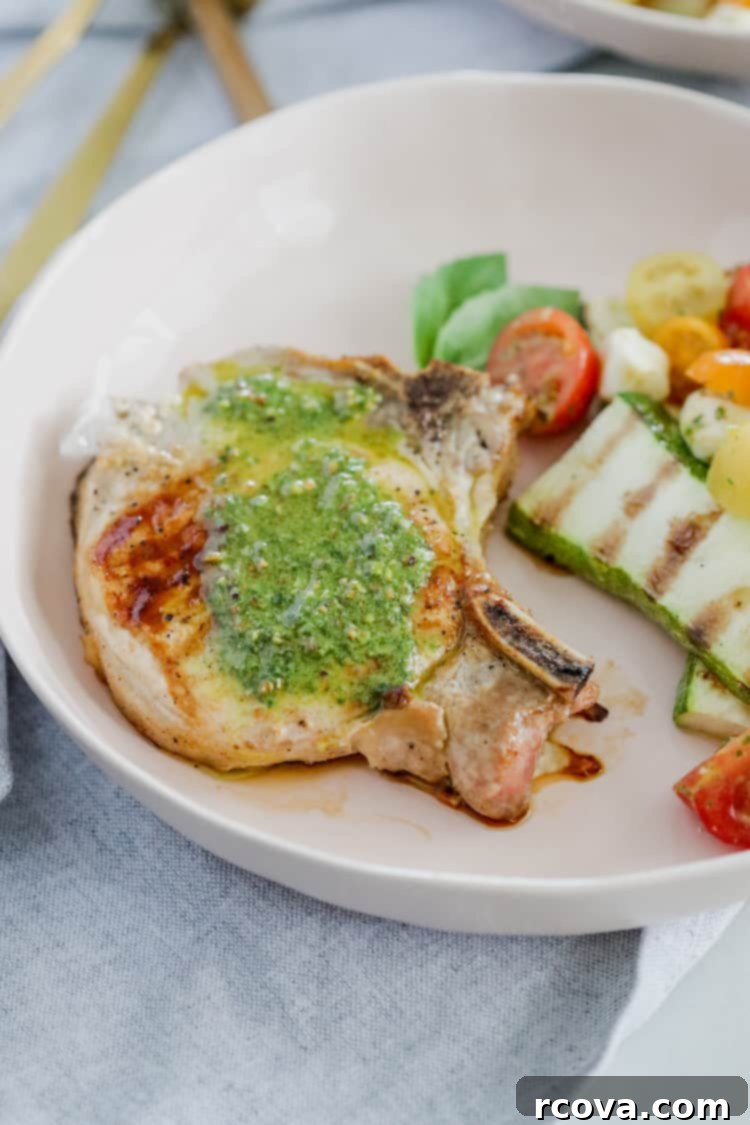 Delicious Pesto Grilled Pork Chops Low Carb Paleo Whole30 3 Delicious Pesto Grilled Pork Chops plated for a quick and easy summer dinner, ready in under 30 minutes. The perfect summer meal with fresh basil pesto!