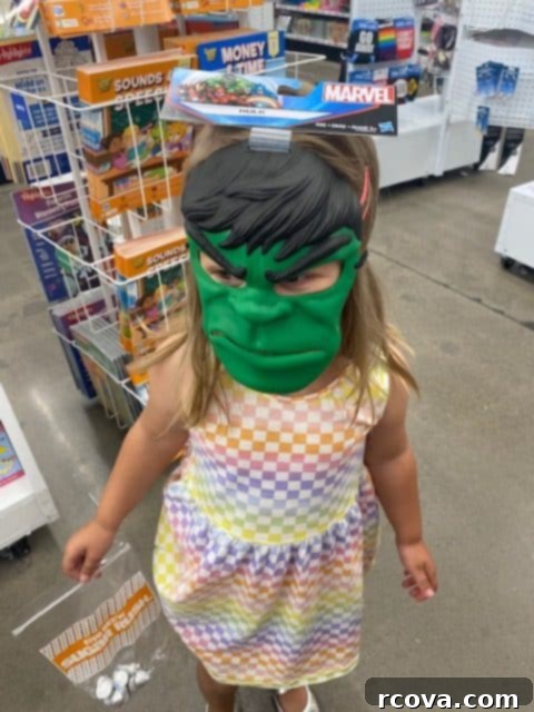 Zesty Mandarin Glazed Cookies 13 A young girl wearing a large, green Hulk mask, posing in a store aisle with shopping carts in the background.