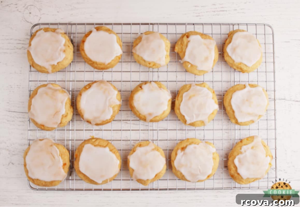 Zesty Mandarin Glazed Cookies 9 A plate of Glazed Mandarin Orange Cookies with a glass of milk, ready to be enjoyed.