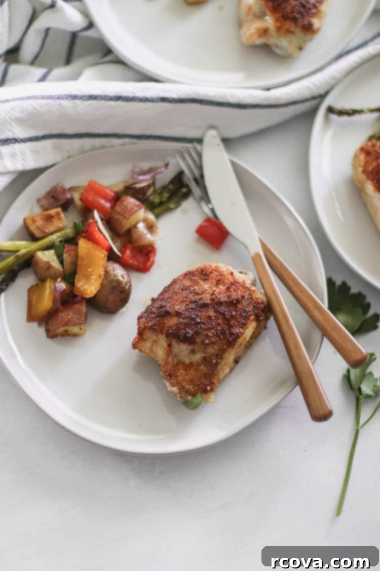 Smoky Paprika Sheet Pan Chicken 2 Juicy roasted paprika chicken thighs and colorful vegetables on a sheet pan