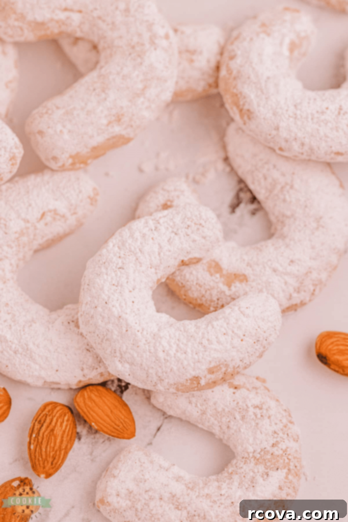 Holiday Cookie Magic: Recipes for Festive Cheer 16 Almond Cinnamon Crescent Cookies on a white plate