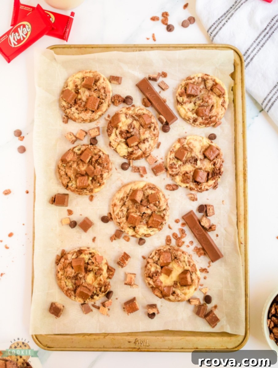 Decadent Kit Kat Cookies 5 Baked Kit Kats incorporated into cookies on a baking tray, fresh from the oven