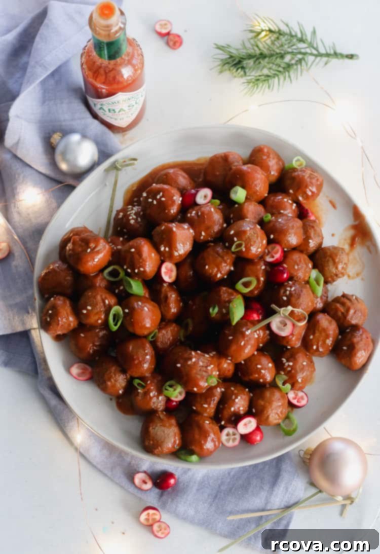 Slow Cooker Sweet and Spicy Cranberry Meatballs 5 Close-up of sweet and spicy cranberry meatballs in a serving dish