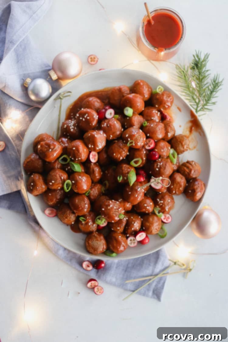 Slow Cooker Sweet and Spicy Cranberry Meatballs 7 Sweet and spicy cranberry meatballs on a serving tray with toothpicks