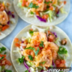 Spicy Bang Bang Shrimp Tacos 10 Assembled bang bang shrimp tacos with a vibrant coleslaw and sauce, ready to be enjoyed