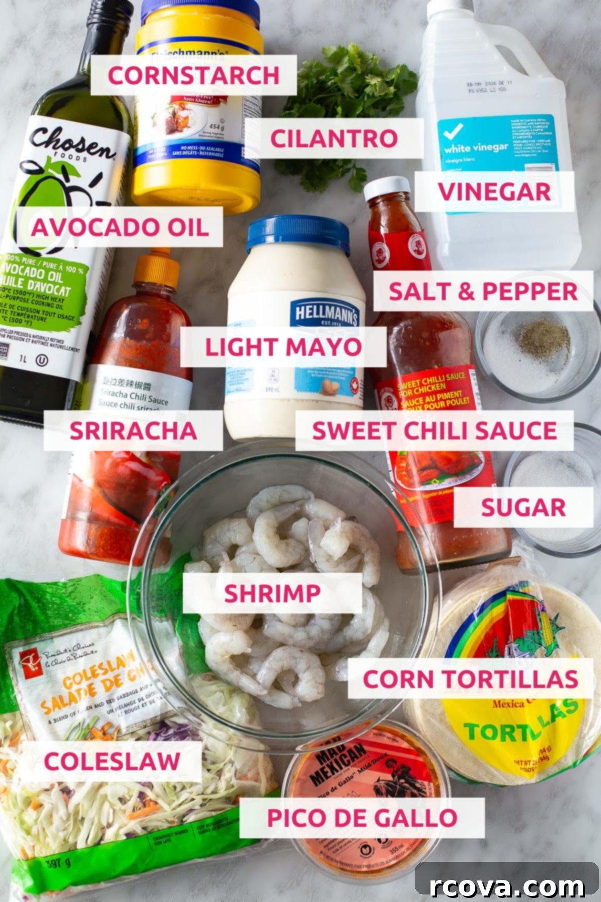 Spicy Bang Bang Shrimp Tacos 4 Ingredients for making bang bang shrimp tacos: cornstarch, cilantro, vinegar, avocado oil, light mayo, salt & pepper, sweet chili sauce, sriracha, sugar, shrimp, corn tortillas, coleslaw and pico de gallo arranged beautifully for a food blog