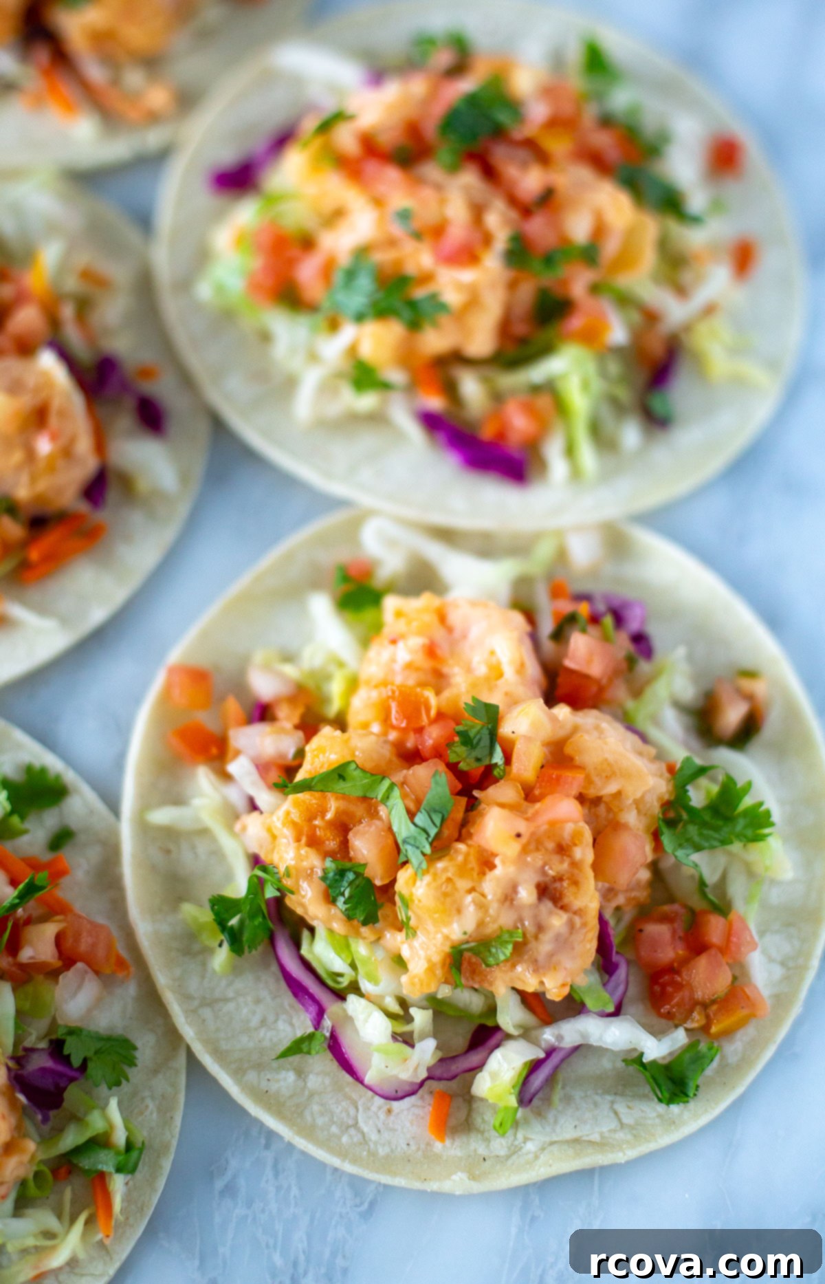 Spicy Bang Bang Shrimp Tacos 9 Assembled bang bang shrimp tacos beautifully presented on a wooden board
