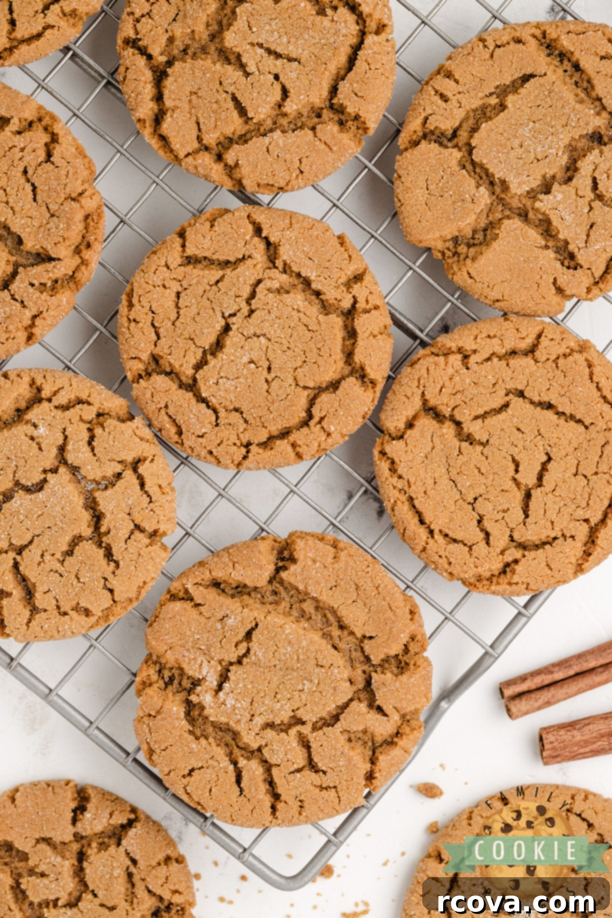 Cozy Ginger-Spiced Cookies 7 Freshly baked soft gingerbread cookies cooling on a wire rack, beautifully arranged with festive ribbon and cinnamon sticks nearby, perfect for holiday gifting or serving.