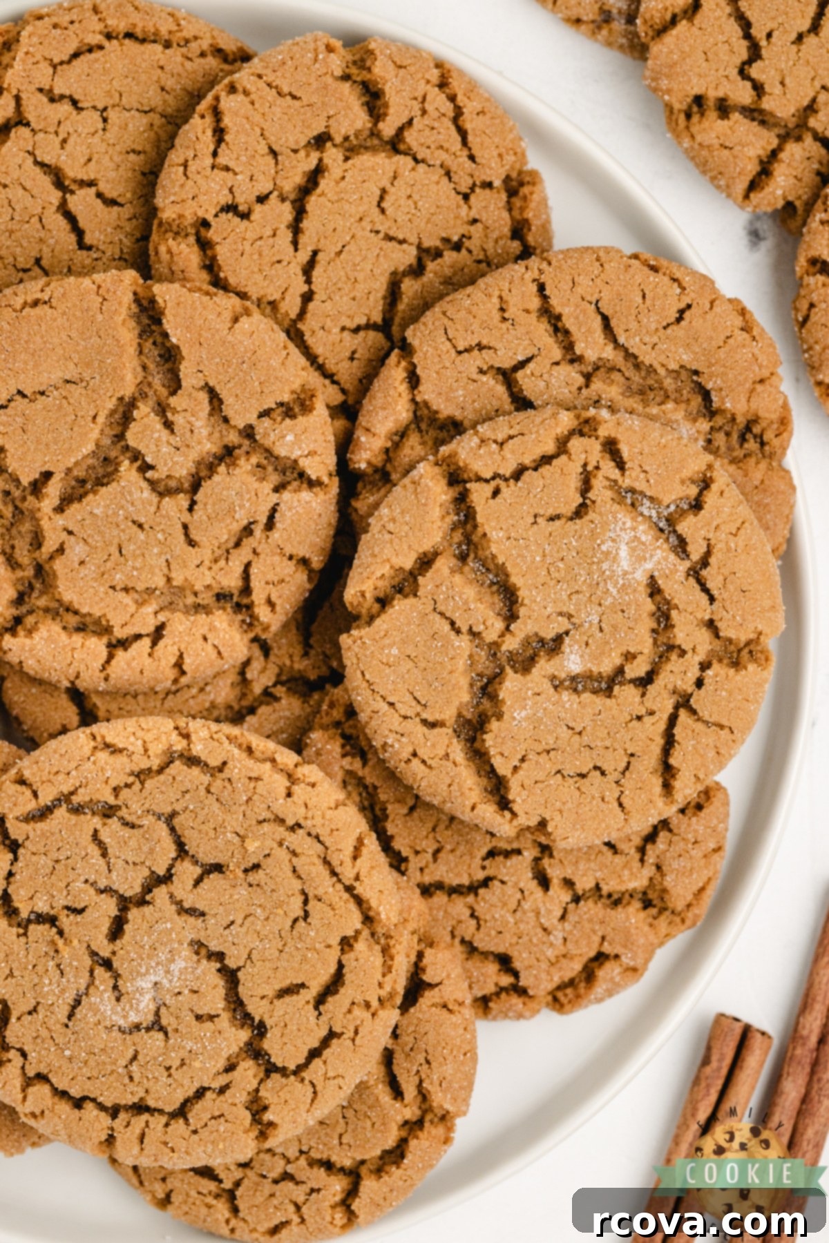Cozy Ginger-Spiced Cookies 8 Close-up of soft gingerbread cookies beautifully stacked on a plate, showcasing their perfectly chewy centers and glistening sugar-dusted tops, inviting a delicious bite.