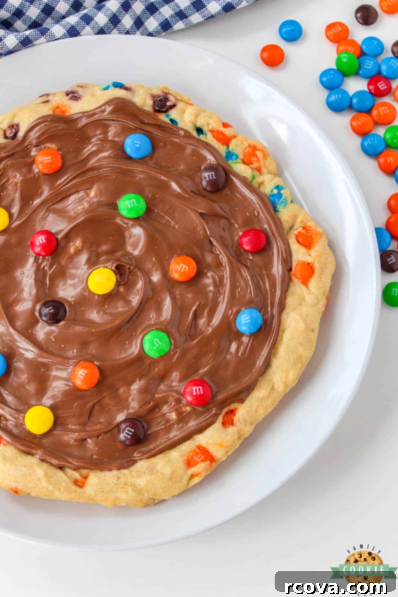 Vibrant M and M Cookie Creation 8 Dessert pizza frosted with milk chocolate and topped with M&Ms