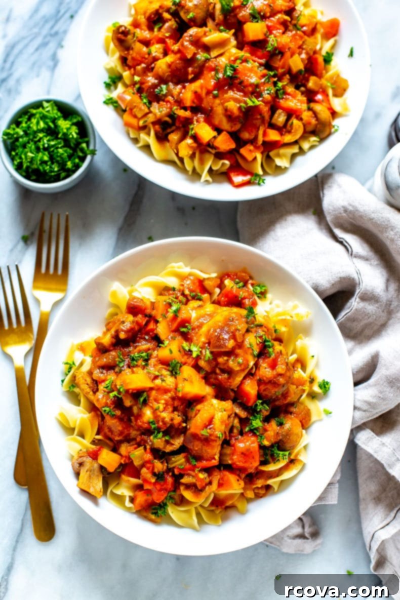Rustic Slow Cooker Chicken Cacciatore 2 Classic Slow Cooker Chicken Cacciatore served with egg noodles and fresh parsley, highlighting the rich sauce and tender chicken.