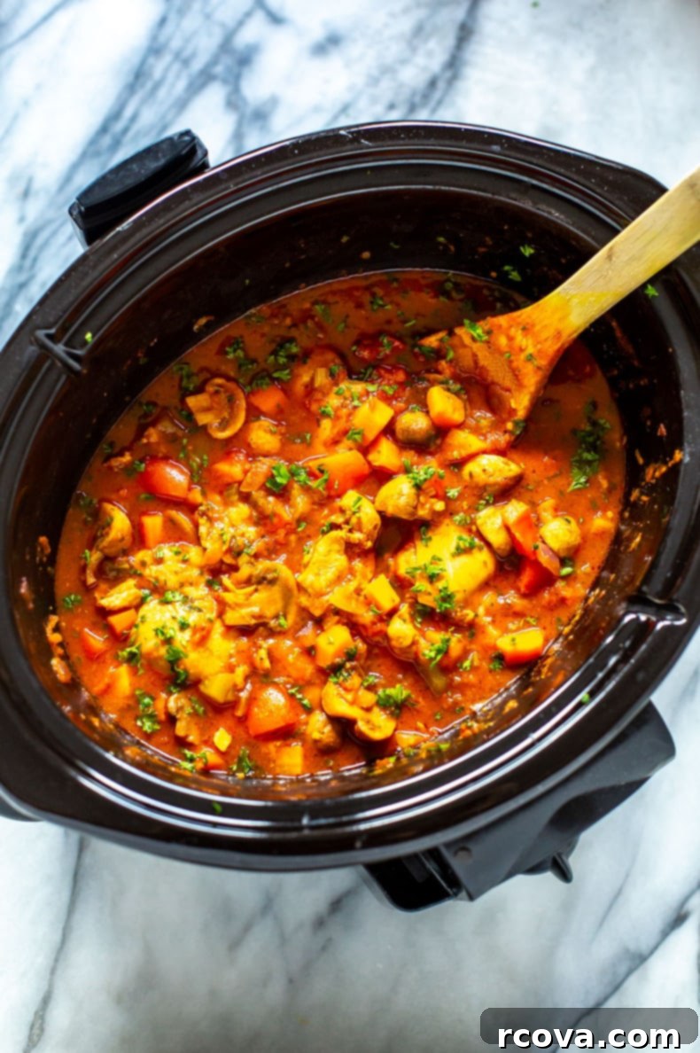 Rustic Slow Cooker Chicken Cacciatore 9 Large pot of Slow Cooker Chicken Cacciatore with a serving spoon, highlighting the rich, comforting texture and abundant vegetables.