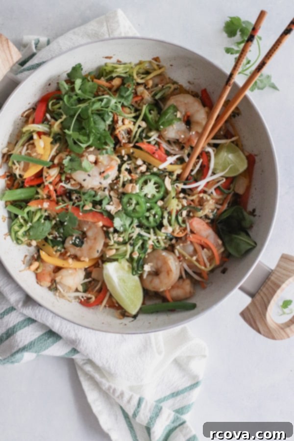 Whole30 Shrimp Pad Thai Paleo Low Carb 2 A vibrant bowl of Whole30 Shrimp Pad Thai with zucchini noodles, fresh cilantro, and a sprinkle of cashews.