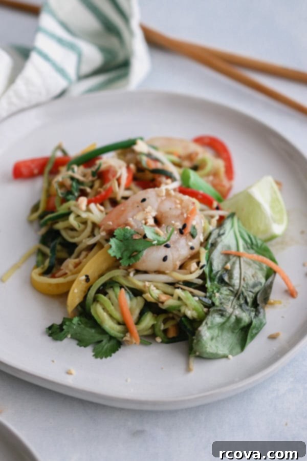 Whole30 Shrimp Pad Thai Paleo Low Carb 3 Close-up of fresh vegetables and shrimp being stir-fried in a skillet, ready for the Whole30 Pad Thai sauce.
