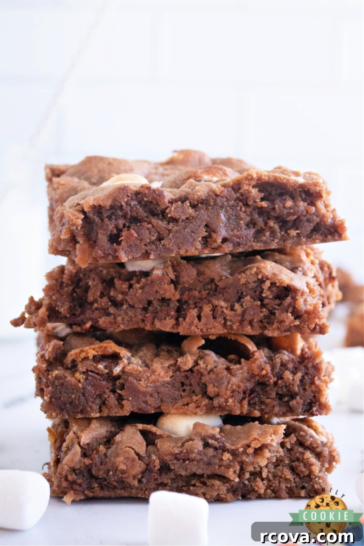 Swiss Miss Chocolate Chip Cookie Bar Bliss 2 Gooey Swiss Miss Chocolate Chip Cookie Bars topped with marshmallows and chocolate chips, evoking the warmth of hot cocoa.