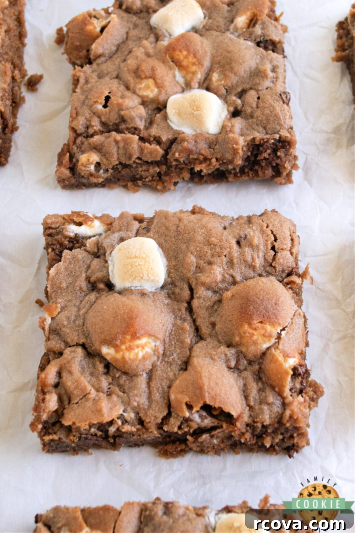 Swiss Miss Chocolate Chip Cookie Bar Bliss 3 Close-up of baked hot cocoa cookie bars with melted marshmallows and chocolate chips, ready to be cut.